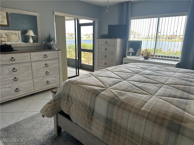 bedroom featuring access to exterior and light tile patterned floors