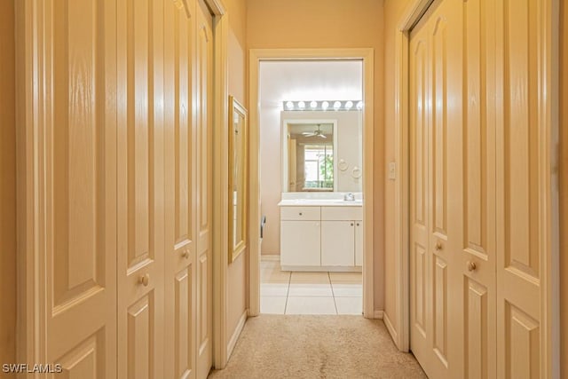 corridor featuring light colored carpet