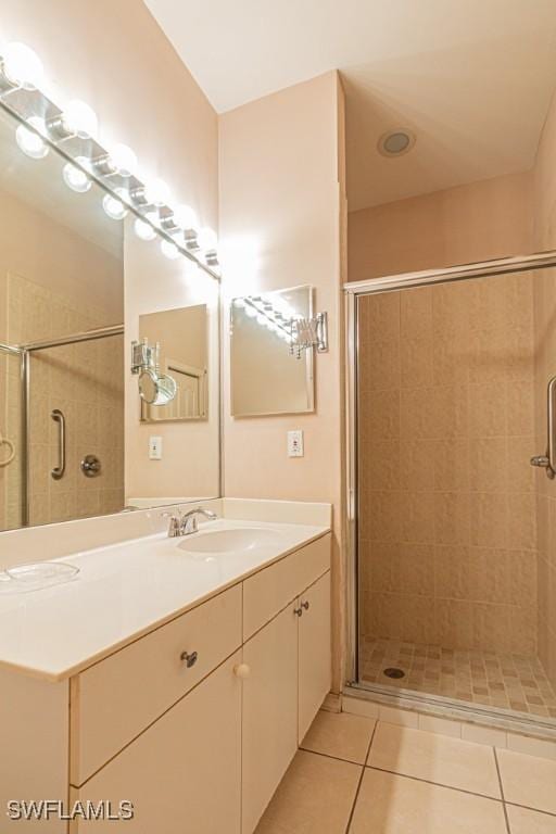 bathroom featuring vanity, tile patterned floors, and a shower with shower door