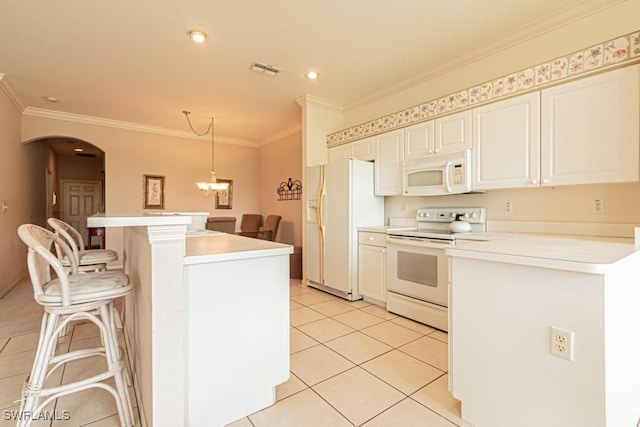 kitchen featuring a kitchen breakfast bar, white appliances, crown molding, light tile patterned floors, and hanging light fixtures