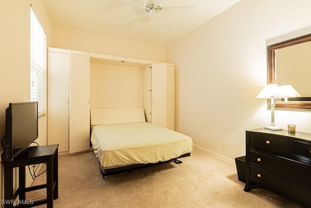 bedroom featuring ceiling fan and light colored carpet