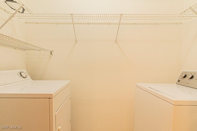 laundry area featuring washing machine and clothes dryer