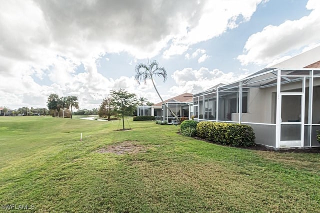 view of yard featuring glass enclosure