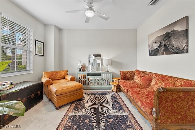 tiled living room with ceiling fan