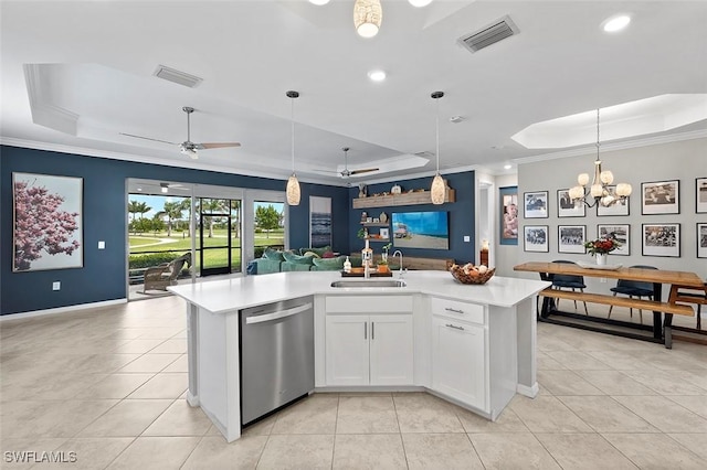 kitchen featuring a raised ceiling, white cabinetry, stainless steel dishwasher, and a kitchen island with sink