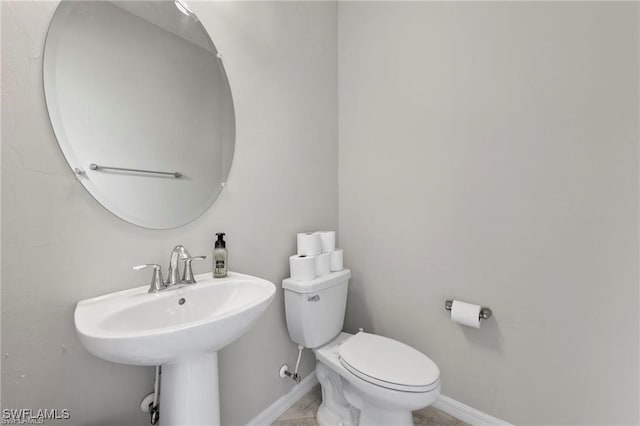 bathroom featuring sink and toilet