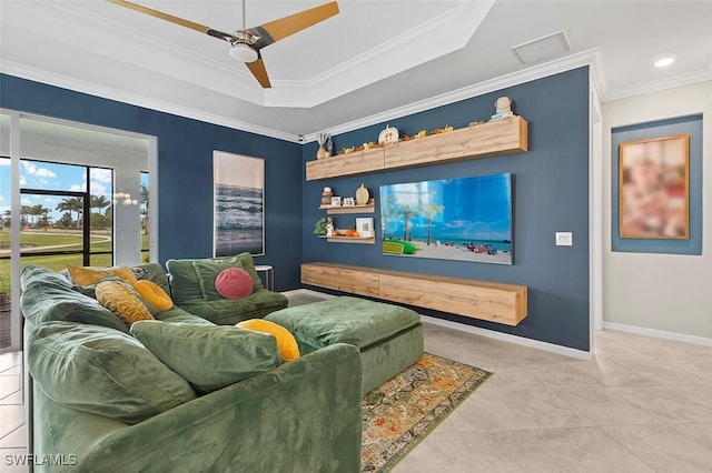 tiled cinema featuring ceiling fan, a raised ceiling, and ornamental molding