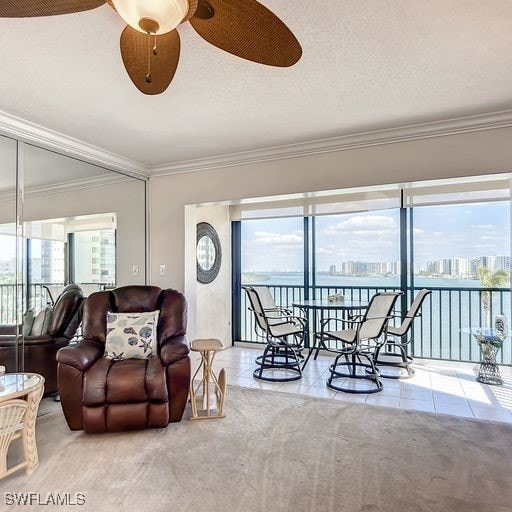 living room with tile patterned floors, ceiling fan, a textured ceiling, and a wealth of natural light