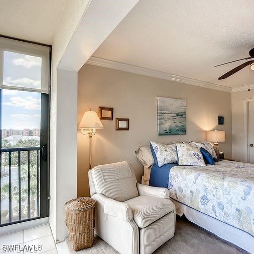 carpeted bedroom with access to outside, ceiling fan, crown molding, and a textured ceiling