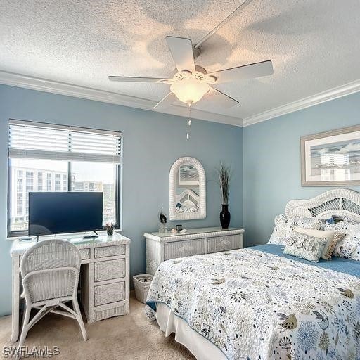 carpeted bedroom featuring ceiling fan, crown molding, and a textured ceiling