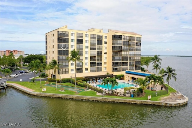 view of property with a water view and a community pool