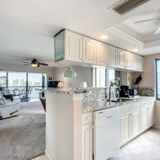 kitchen featuring white cabinets, kitchen peninsula, and white dishwasher