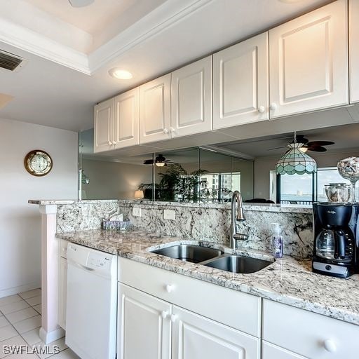 kitchen with white dishwasher, decorative backsplash, white cabinets, and sink