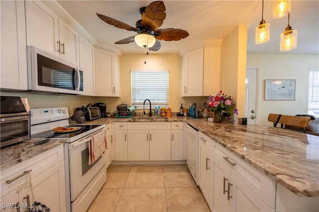 kitchen with white appliances, ceiling fan, sink, decorative light fixtures, and white cabinets