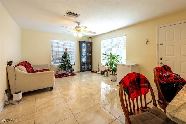 living room with ceiling fan and light tile patterned floors