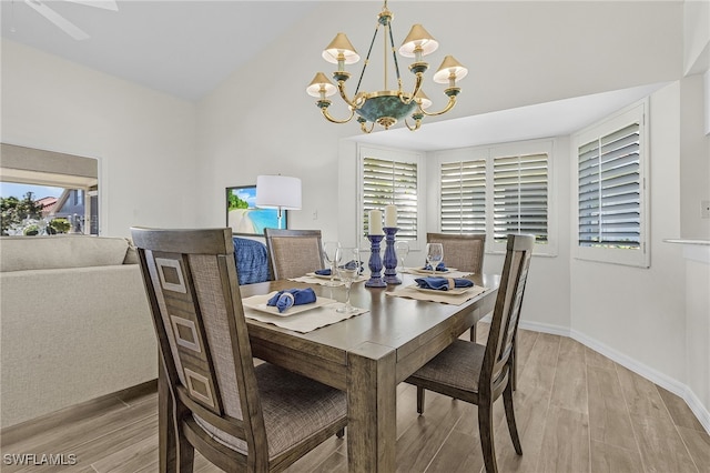 dining space with a wealth of natural light, light hardwood / wood-style flooring, and a chandelier