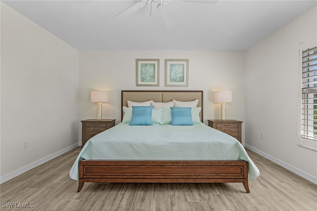 bedroom with light hardwood / wood-style flooring and ceiling fan