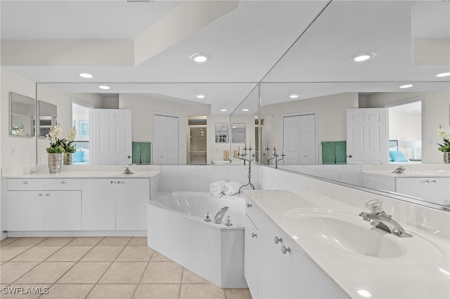 bathroom featuring tile patterned floors, a washtub, and vanity