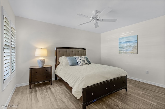 bedroom with hardwood / wood-style floors and ceiling fan