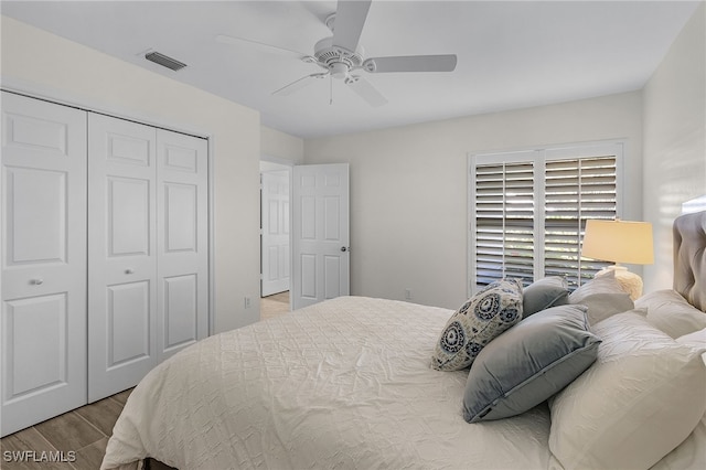 bedroom featuring hardwood / wood-style flooring, ceiling fan, and a closet