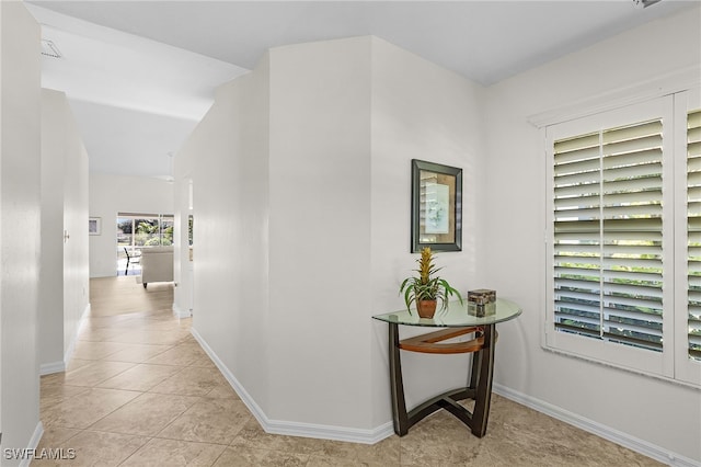 hall featuring light tile patterned flooring