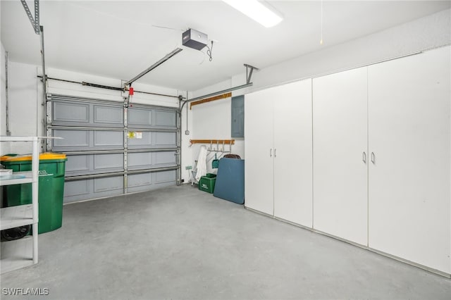 garage with electric panel and a garage door opener