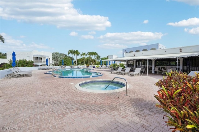 view of pool with a community hot tub and a patio