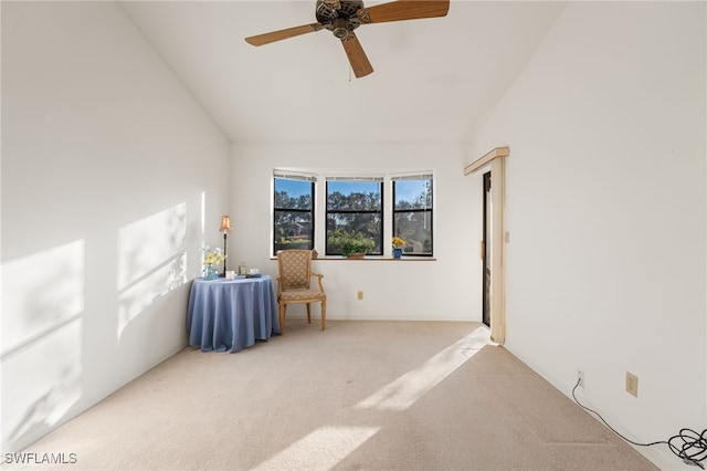 carpeted empty room featuring ceiling fan and lofted ceiling