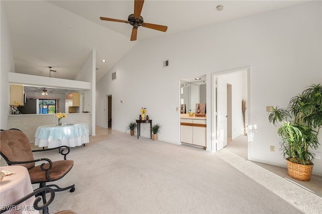 living room featuring light carpet, high vaulted ceiling, and ceiling fan