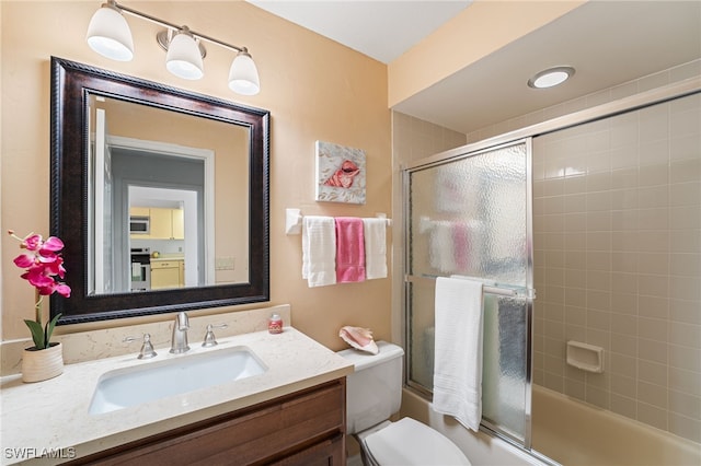 full bathroom with vanity, toilet, and enclosed tub / shower combo