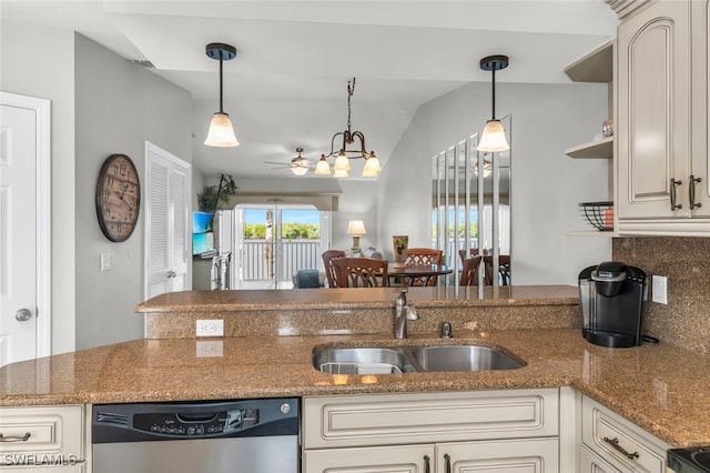 kitchen with pendant lighting, stainless steel dishwasher, dark stone countertops, and sink