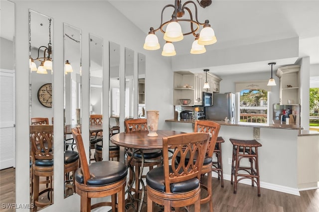 dining space with a chandelier and dark wood-type flooring