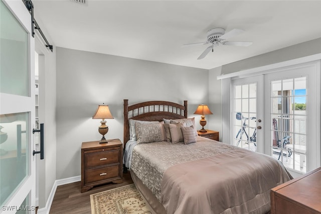 bedroom featuring access to exterior, ceiling fan, french doors, dark wood-type flooring, and a barn door