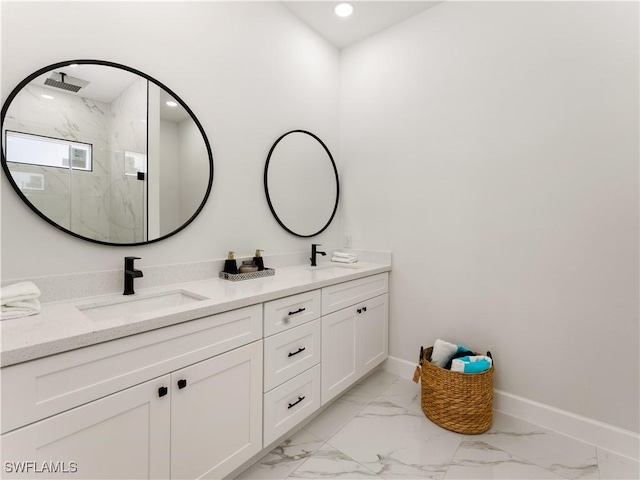 bathroom featuring a shower with door and vanity