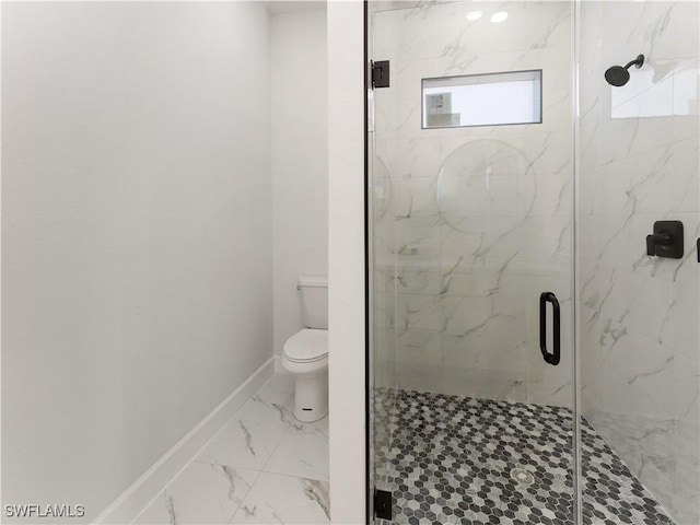 bathroom with a shower with shower door and toilet