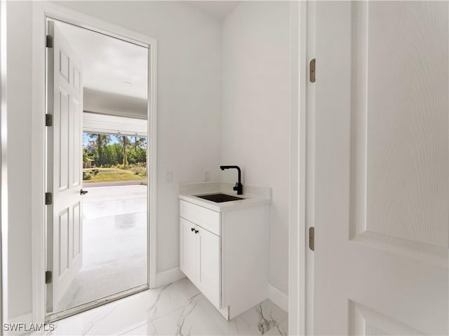 clothes washing area featuring sink