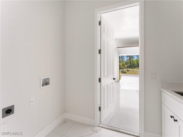 laundry room with electric dryer hookup, hookup for a washing machine, and cabinets