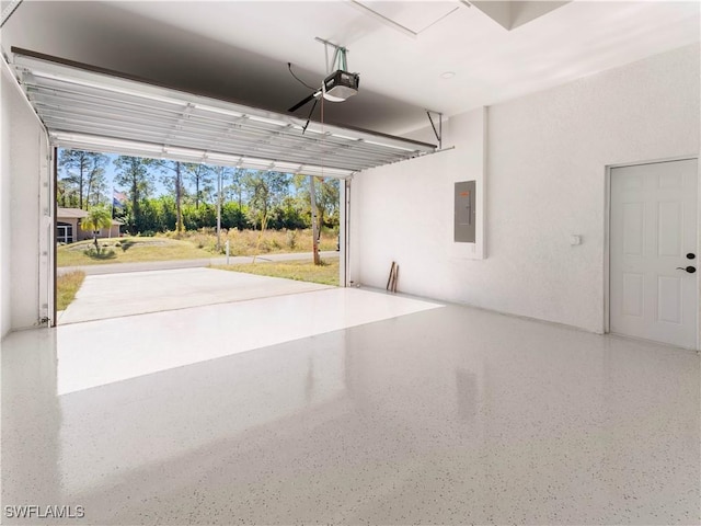 garage featuring electric panel and a garage door opener