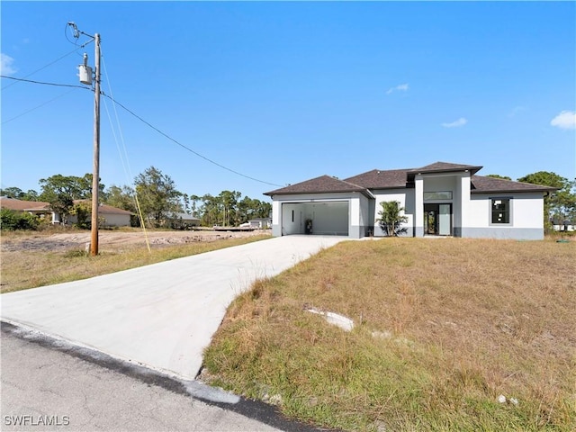 view of front of home featuring a front lawn and a garage