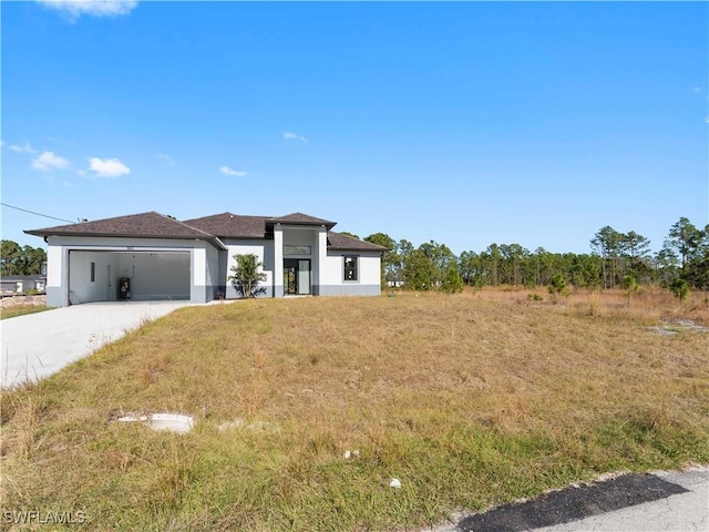 view of front of home featuring a garage and a front lawn