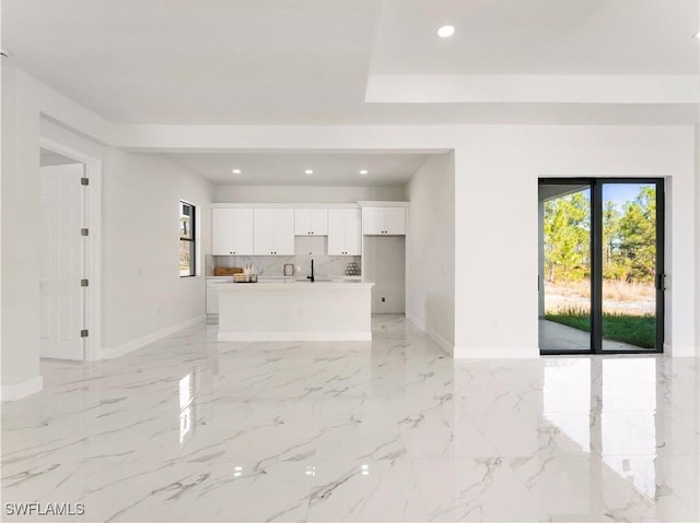 unfurnished living room featuring sink