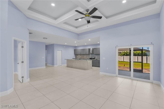 kitchen featuring ceiling fan, a center island, light tile patterned floors, and coffered ceiling