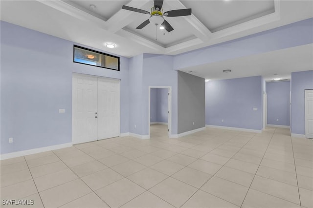 tiled empty room with ceiling fan, beam ceiling, and coffered ceiling