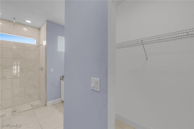 bathroom featuring tile patterned floors and tiled shower