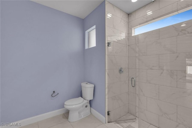 bathroom with tile patterned floors, toilet, and walk in shower