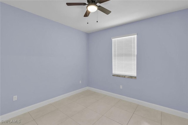 tiled spare room with ceiling fan