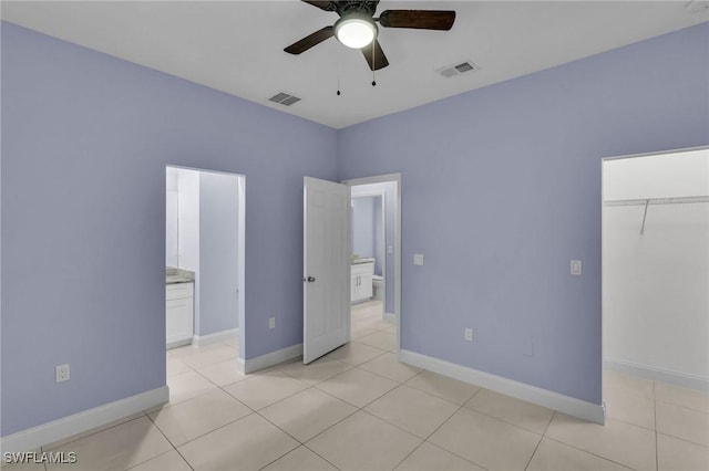 unfurnished bedroom featuring ceiling fan, light tile patterned floors, and a closet