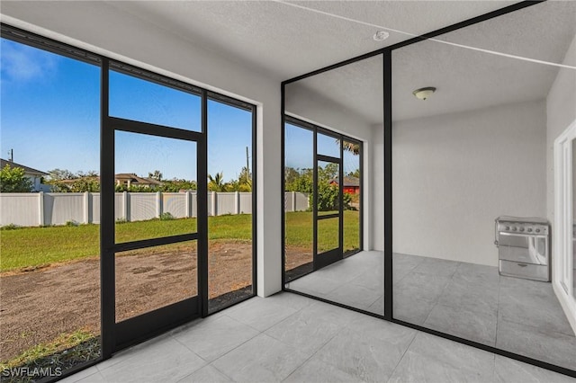 unfurnished sunroom with heating unit