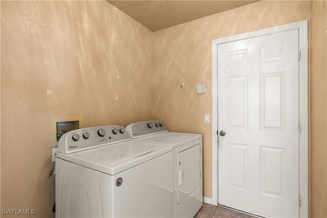 laundry area featuring light tile patterned flooring and washer and dryer