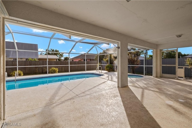 view of swimming pool with a lanai and a patio